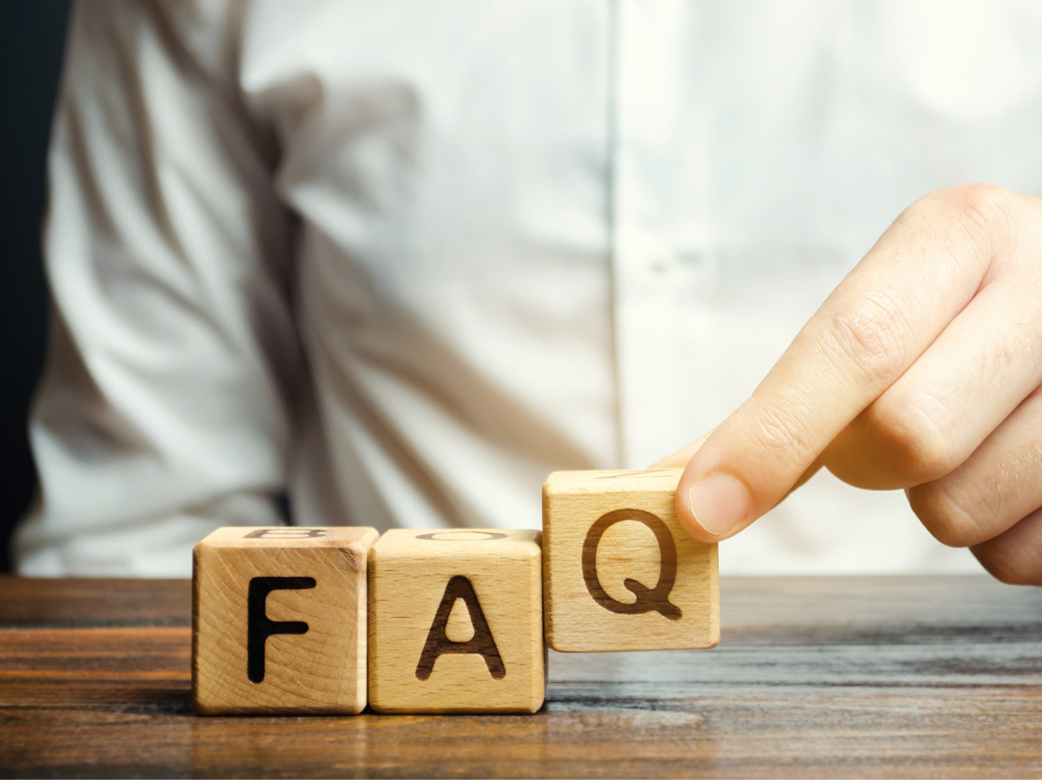 Questions and answers on topics related to Brändle. There are three cubes with the letters FAQ.