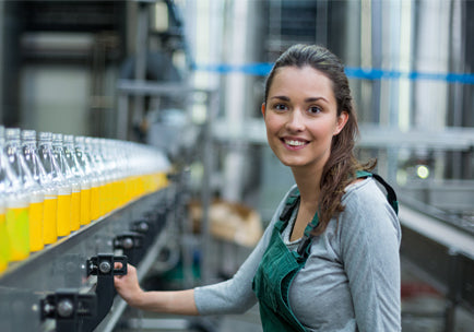 Trainee stands at a filling line