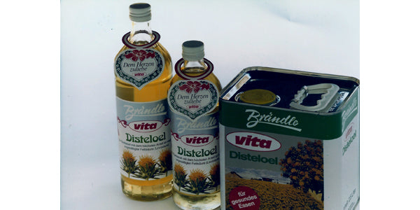 Representation of vita safflower oil, in a glass bottle and in a tin can.